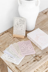 Pack of affirmation cards on wooden table.