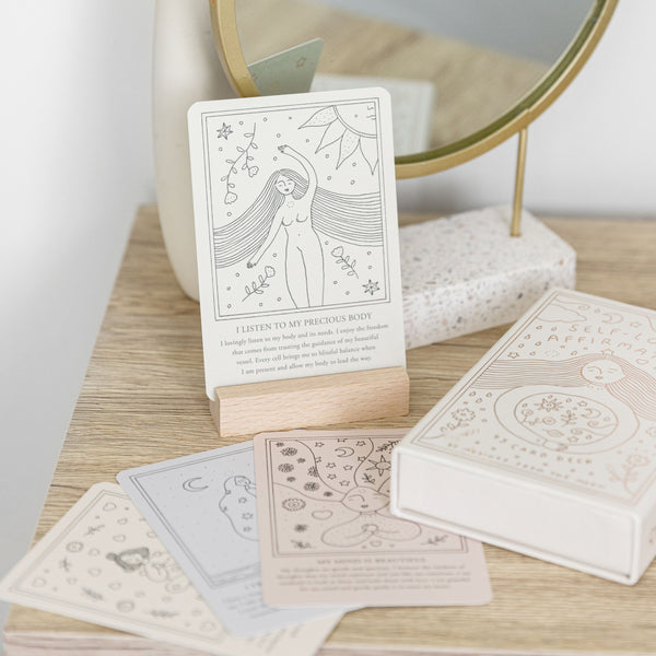 Affirmation card standing in wooden holder.