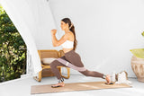 Woman exercising with loop band, ankle weights and sliders.