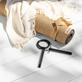 Jute mat laying on white deck with skipping rope and towel.