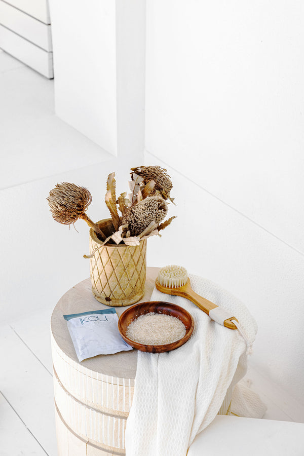 Bowl of bath salts on a wooden table.